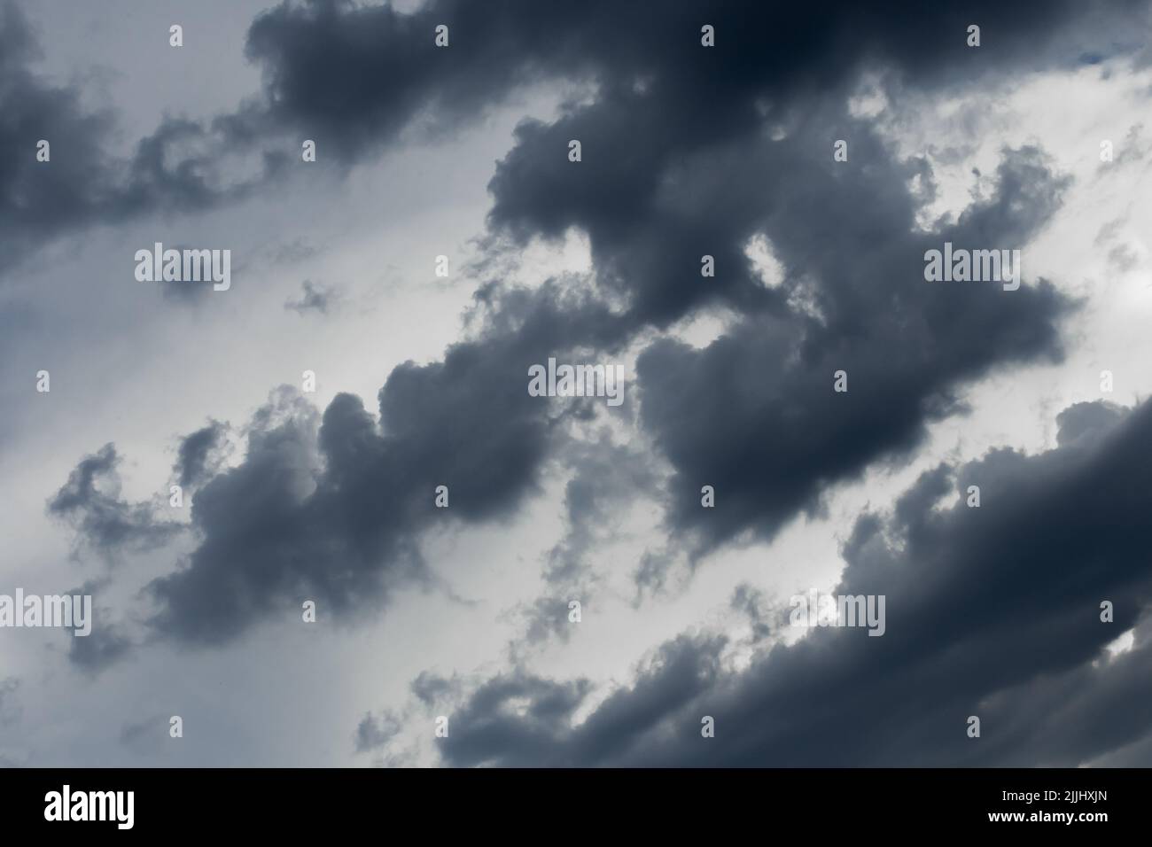 Dark blue and gray heavy rain clouds weather change bad weather background nature. Stock Photo
