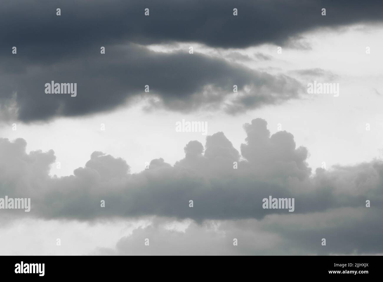 Dark blue and gray heavy rain clouds weather change bad weather background nature. Stock Photo