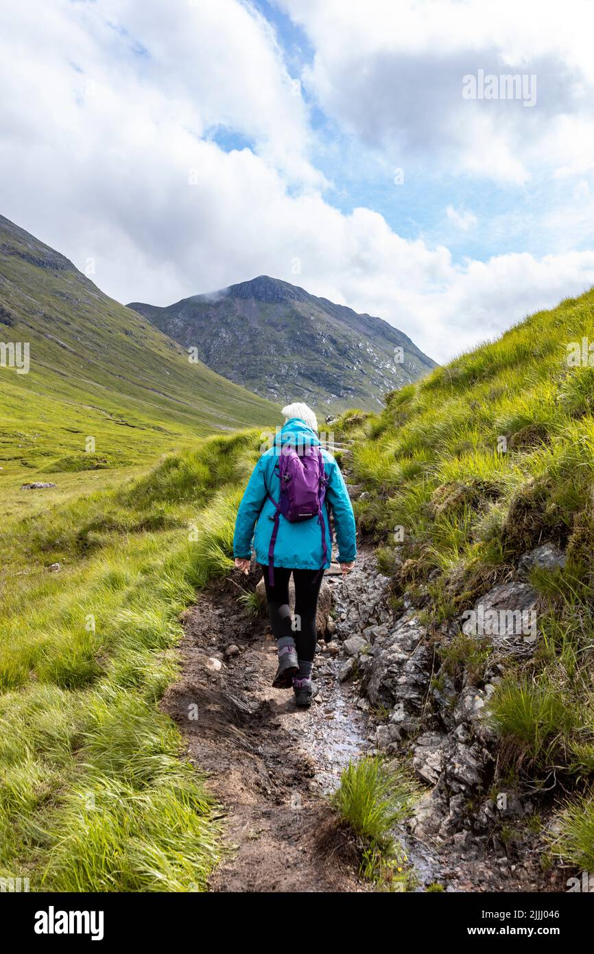 Woman hiking towards Glen Etive by Lairig Gartain, scottish highlands
