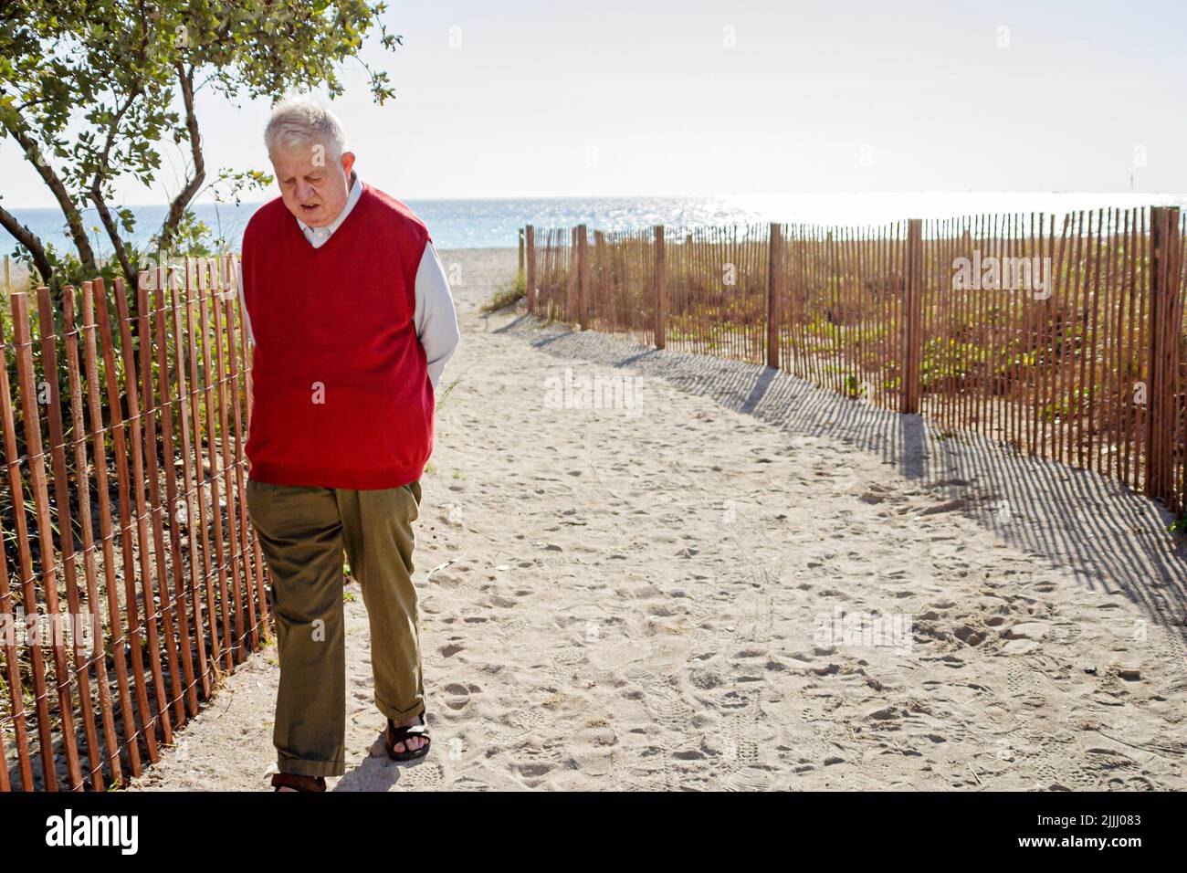 Miami Beach Florida,senior seniors old citizen citizens pensioner pensioners retired elderly,public beach beaches,sand path Stock Photo