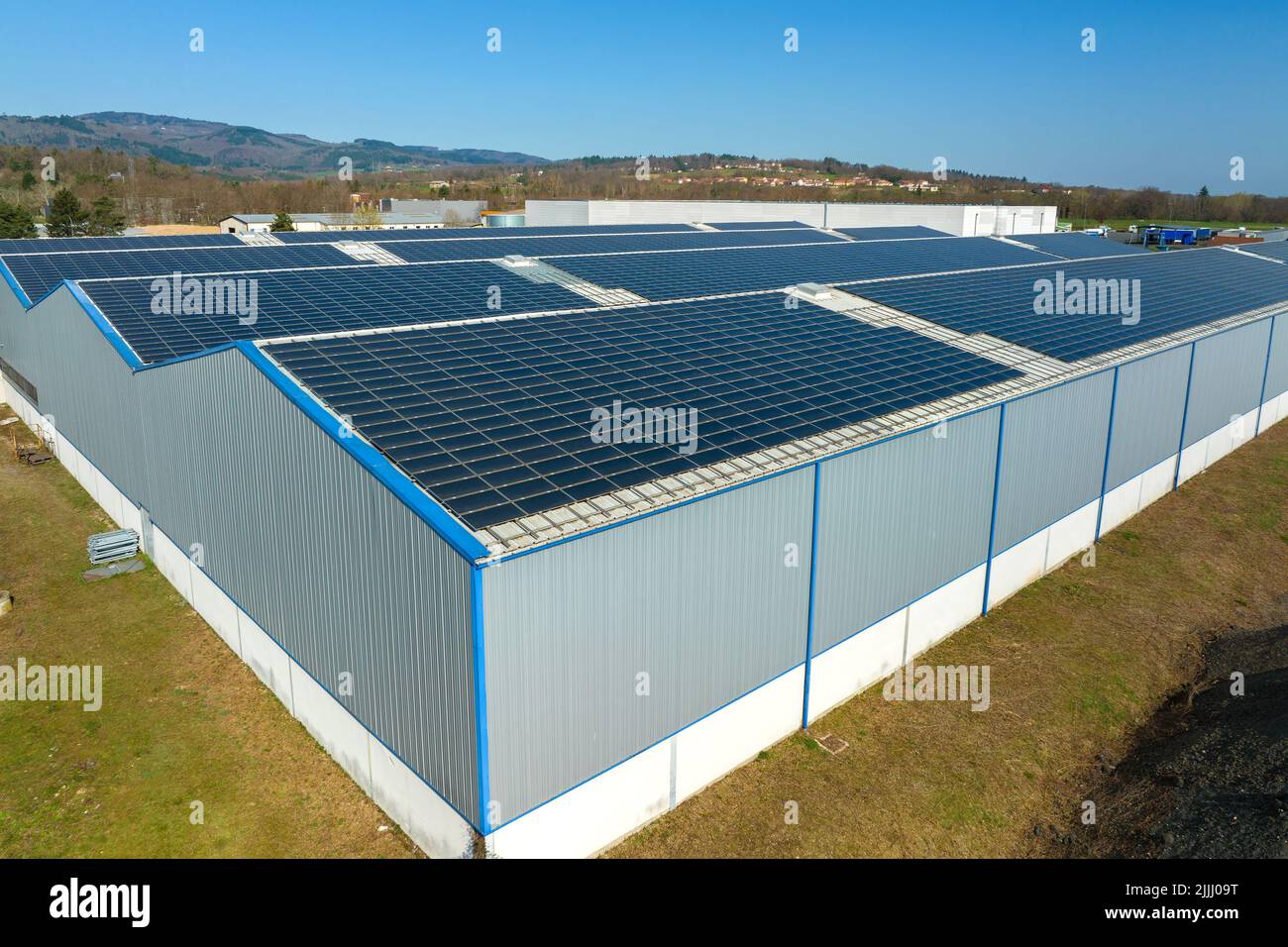 Aerial view of blue photovoltaic solar panels mounted on industrial ...