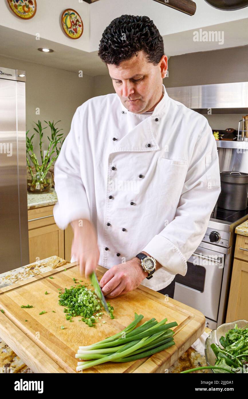 Florida Kendall,Hispanic Latin Latino ethnic immigrant immigrants minority,adult man male,chef makes how to cook video,kitchen cooking cutting celery Stock Photo