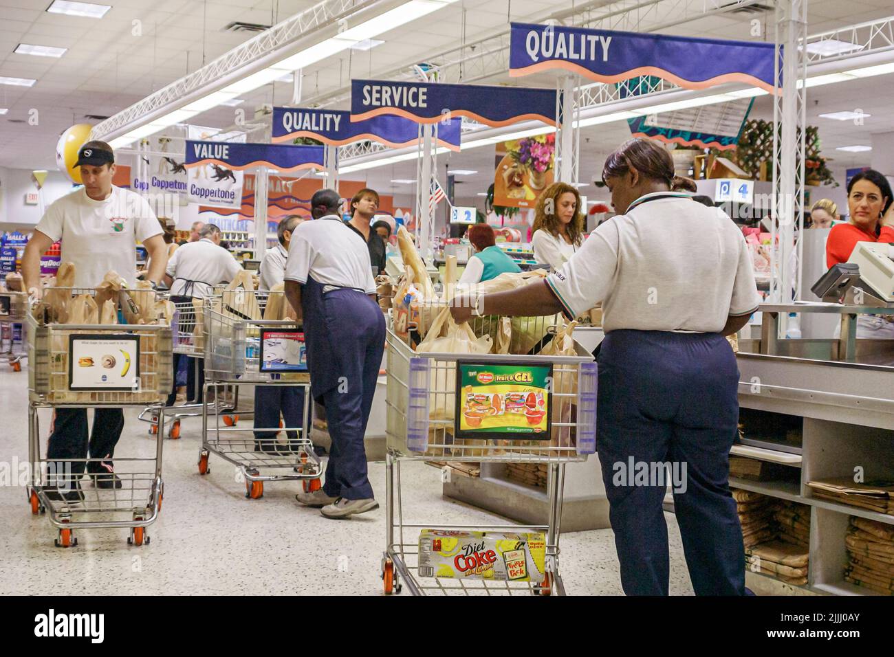 Miami Beach Florida,Publix Grocery Store inside interior checkout line queue cashiers baggers Black man men male workers working employees Stock Photo