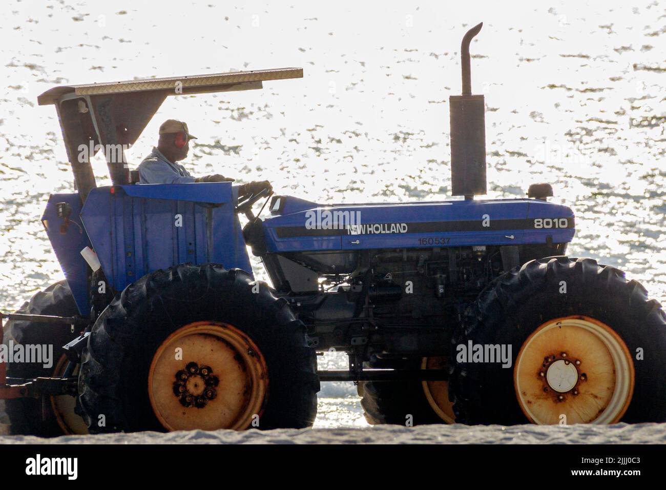 Miami Beach Florida,city tractor,equipment,cleaning beach beaches,a photo silhouette on Stock Photo