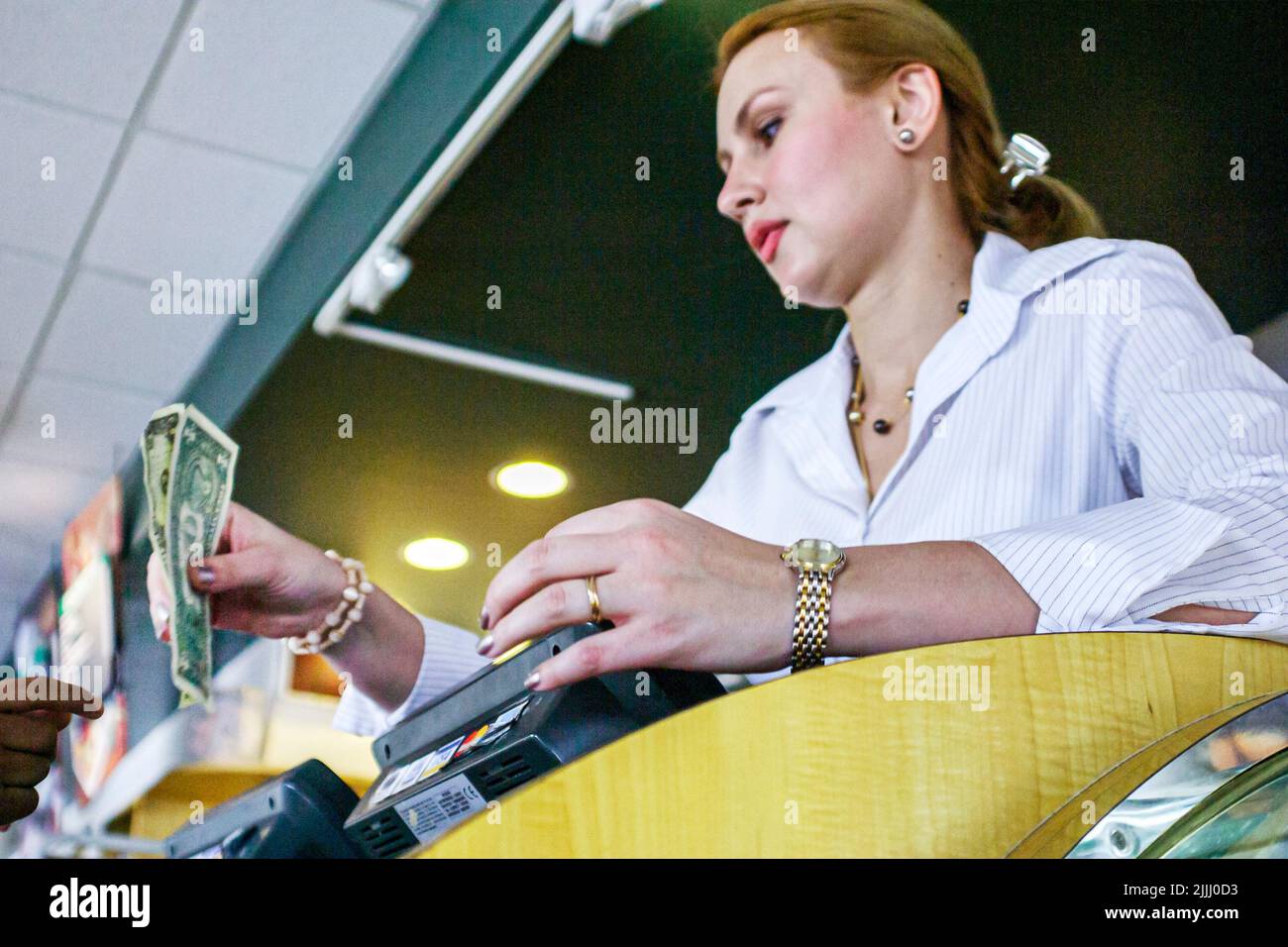 Miami Florida,Coral Gables,restaurant cashier hostess server adult adults woman women female lady,employee employees worker workers working money Stock Photo