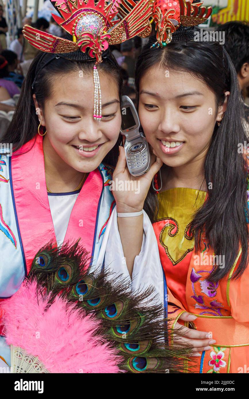 Florida Kendall,Miami Dade College,school,campus,Chinese New Year Festival dance costume women woman female Asian Asians,talking cell phone Stock Photo