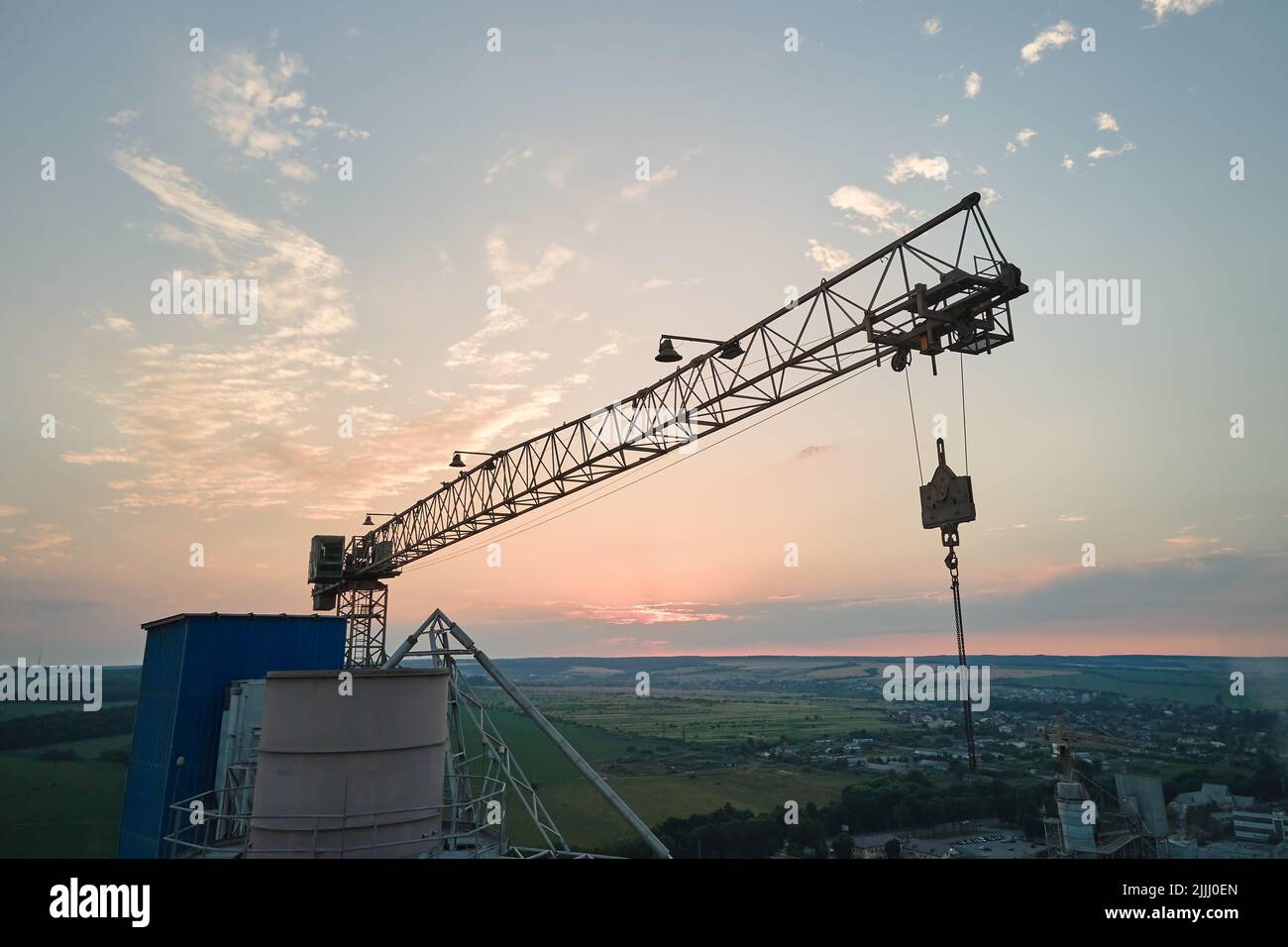Aerial view of cement factory under construction with high concrete plant structure and tower cranes at industrial production area. Manufacture and Stock Photo