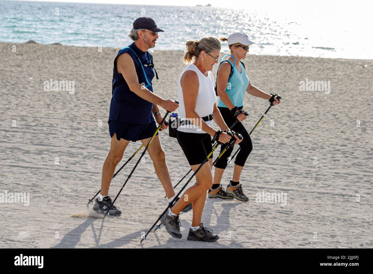 Miami Beach Florida,Atlantic Ocean Shore shoreline coast coastline seashore, Nordic walking poles ski public,sand,exercising workout working out Stock Photo