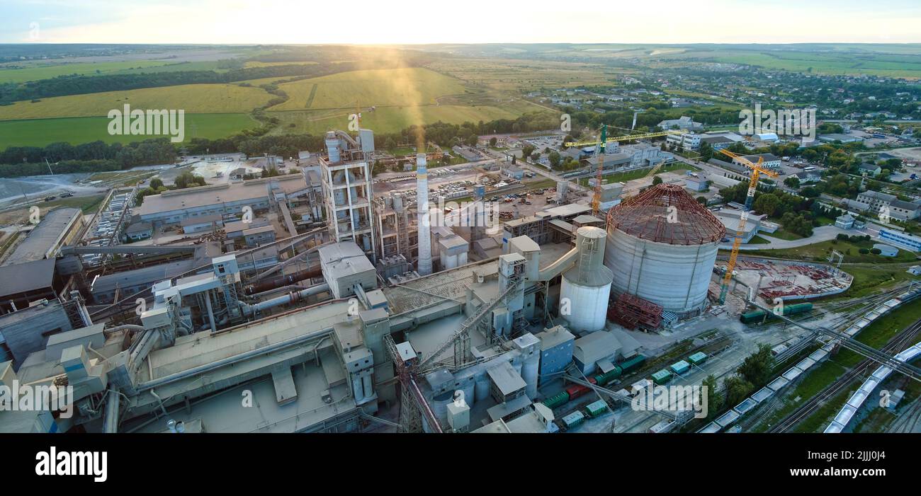 Aerial view of cement factory tower with high concrete plant structure at industrial production area. Manufacturing and global industry concept Stock Photo
