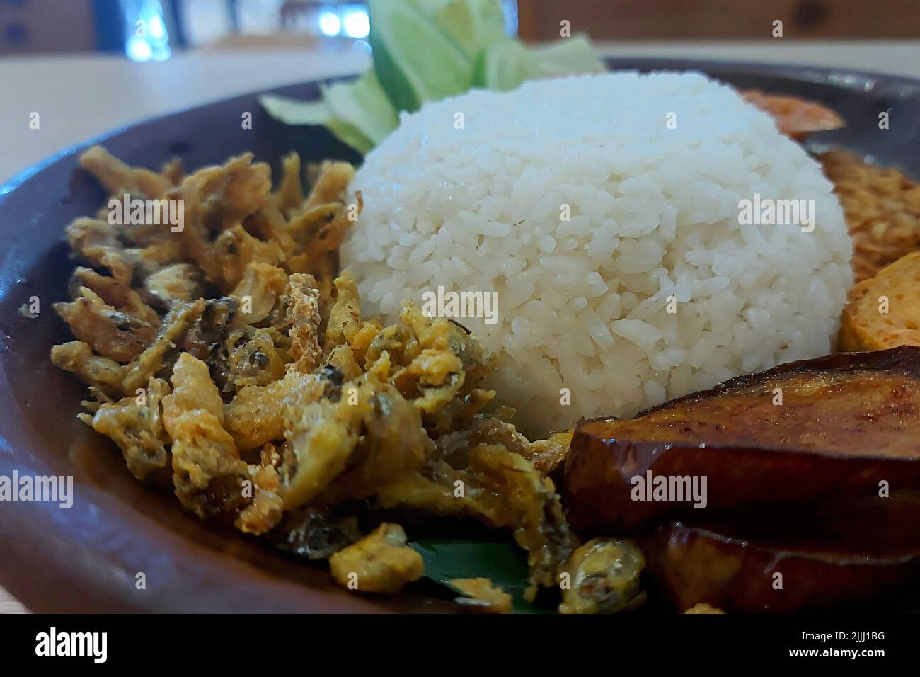 Rice and Fried Baby Fish Penyet at Cafe Jakarta Indonesia Stock Photo