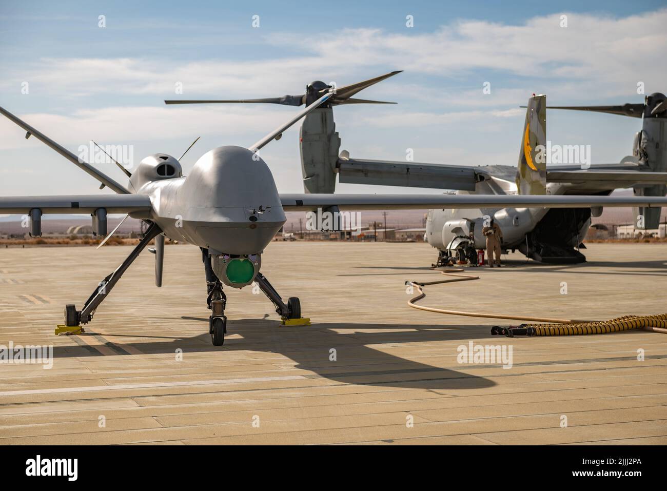 An MQ-9 Reaper assigned to the 163 Attack Wing, March Air Reserve Base stages for refueling on the Strategic Expeditionary Landing Field on Marine Corps Air Ground Combat Center Twentynine Palms, CA July 21, 2022.The 163d accelerated change by pioneering the first ever refuel of the MQ-9 Reaper using a Forward Area refueling Point provided by the VMM - 764’s V-22 Osprey. (U.S. Air National Guard photo by Staff Sgt. Joseph Pagan) Stock Photo