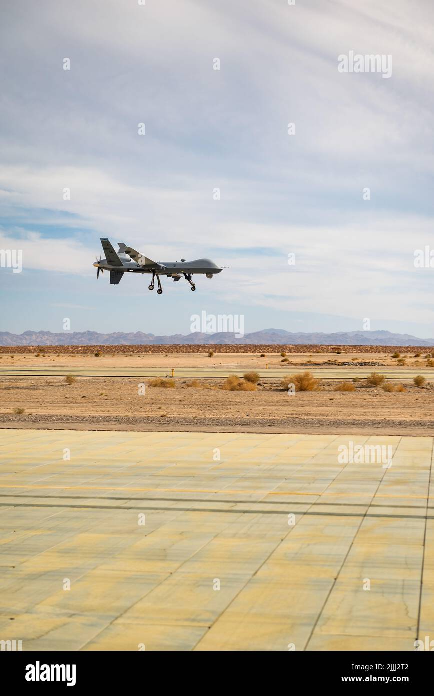 An MQ-9 Reaper assigned to the 163 Attack Wing, March Air Reserve Base approaches runway on the Strategic Expeditionary Landing Field on Marine Corps Air Ground Combat Center Twentynine Palms, CA July 21, 2022.The 163d accelerated change by pioneering the first ever refuel of the MQ-9 Reaper using a Forward Area refueling Point provided by the VMM - 764’s V-22 Osprey. (U.S. Air National Guard photo by Staff Sgt. Joseph Pagan) Stock Photo