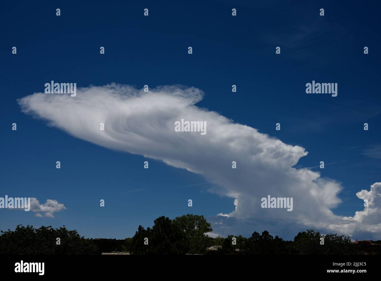 Towering cumulonimbus clouds form on the horizon in New Mexico near Santa Fe. Stock Photo