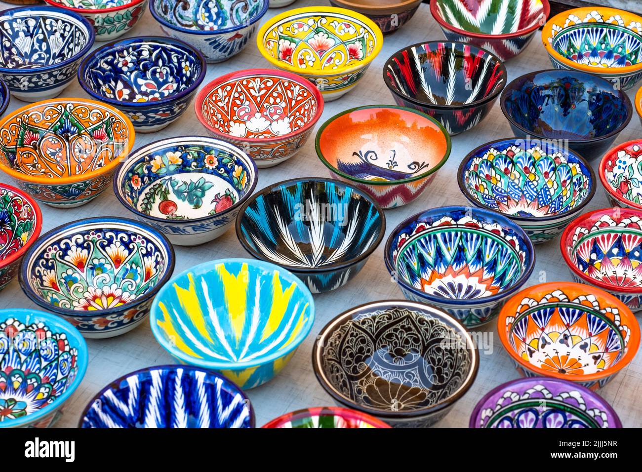 Decorative ceramic plates with traditional uzbek ornament in the street market of Bukhara. Uzbekistan Stock Photo