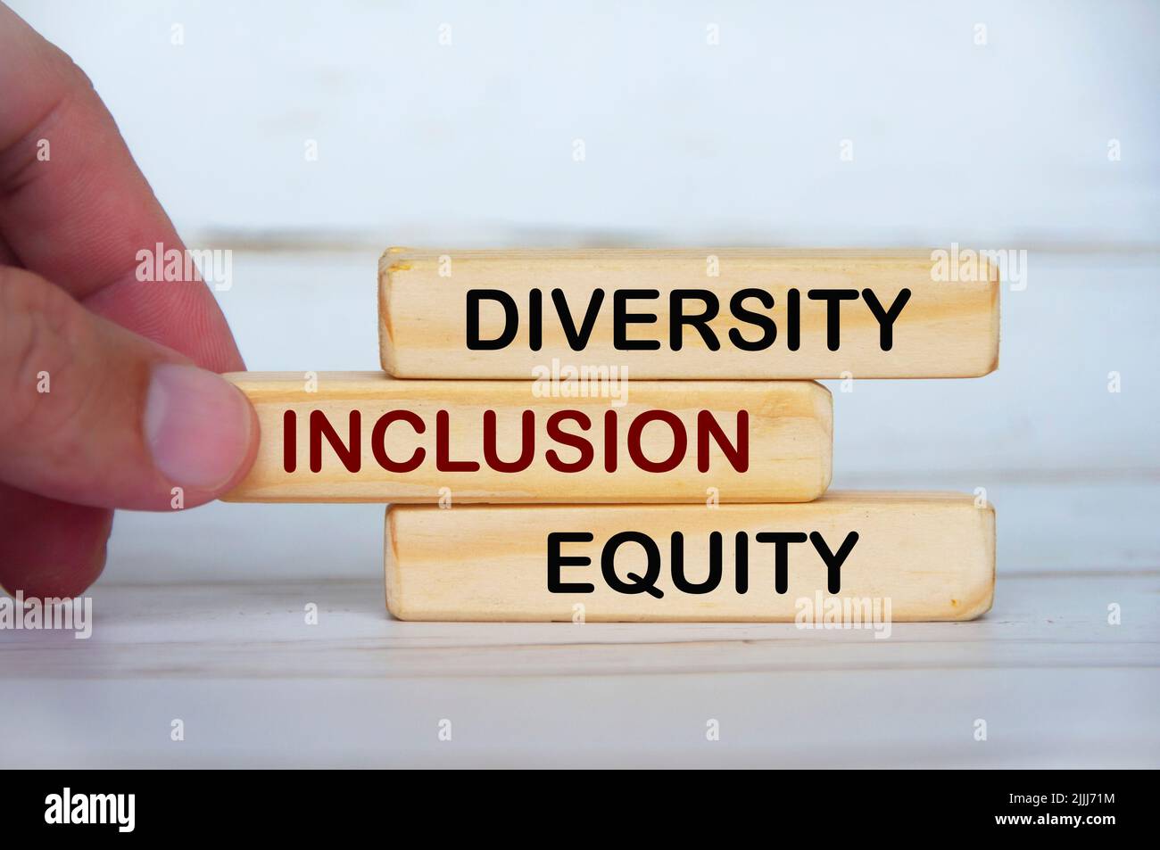 Hand holding wooden blocks with text - Diversity, inclusion and equity. Business culture concept Stock Photo