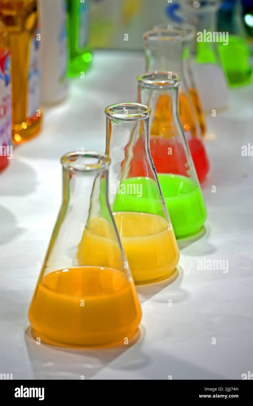 rainbow liquid glass container heap closeup, chemical perfume substance diversity Stock Photo