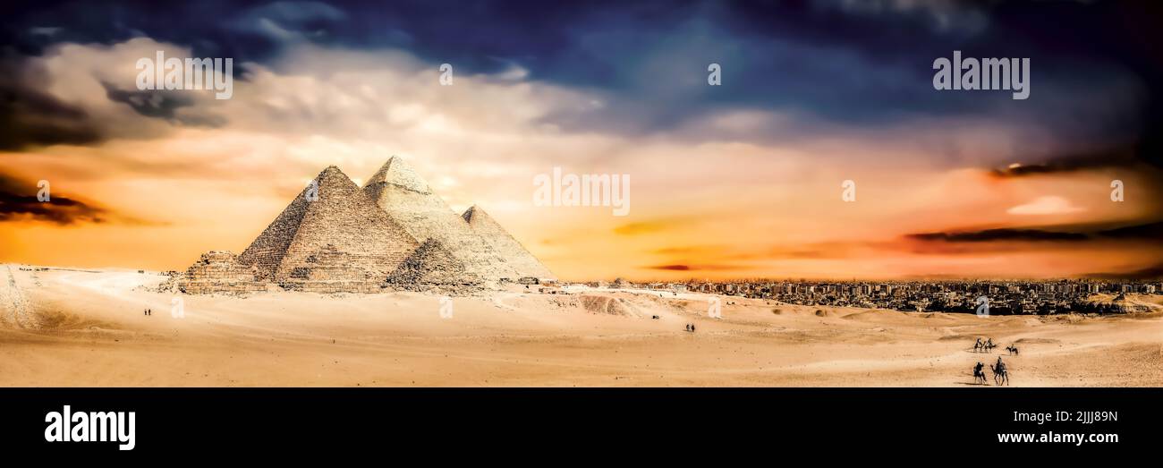 Picturesque photo of the Great Pyramids of Giza taken at a scenic, romantic sunset. The almost most imposing ancient wonders of the world. Stock Photo