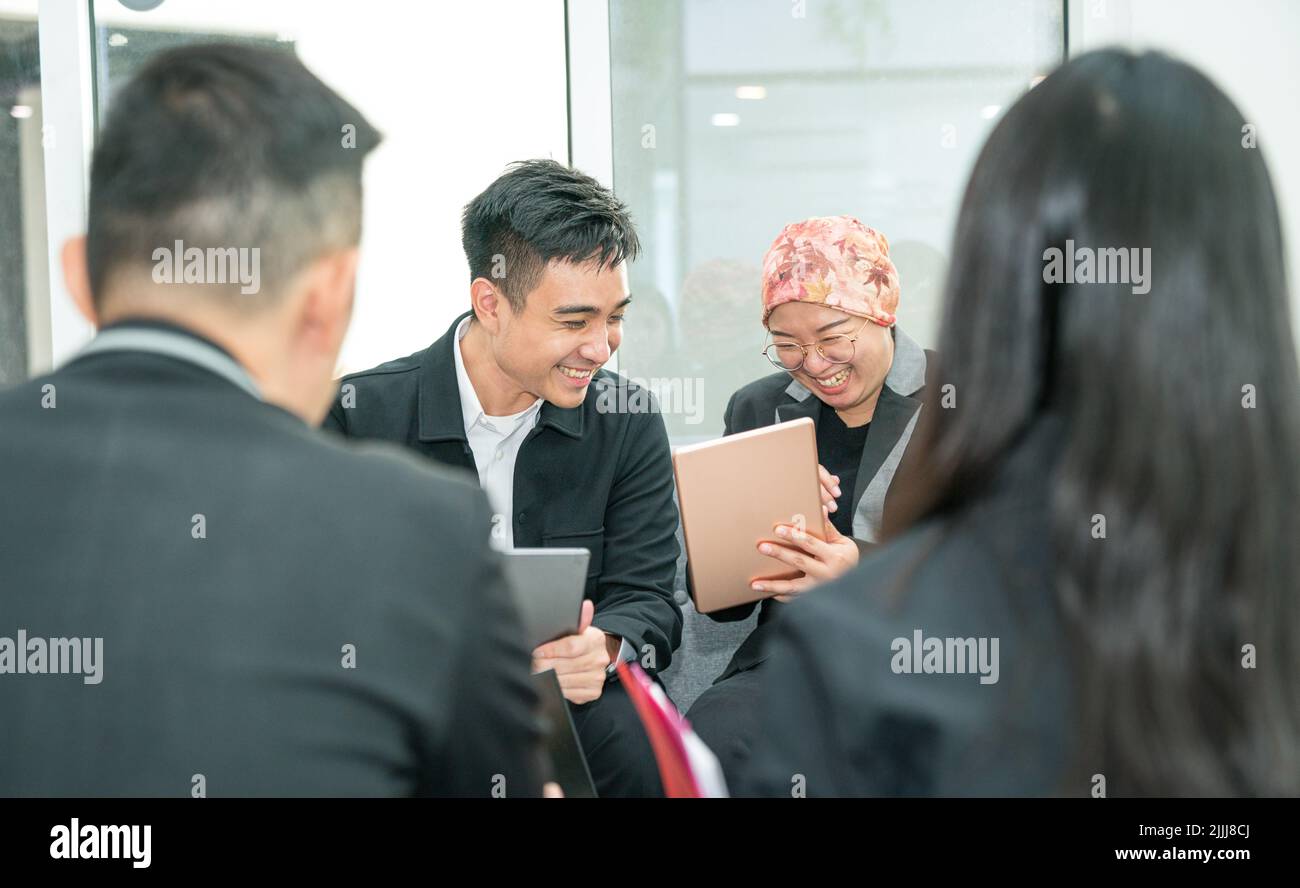 Business office colleagues laughing over a joke while having a meeting. Positive and fun corporate culture. Stock Photo