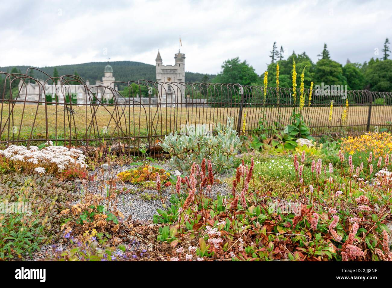 Balmoral Castle, private Royal Family residence in Aberdeenshire, viewed  from the estate gardens with flowers in bloom, summer day,Scotland,UK Stock Photo