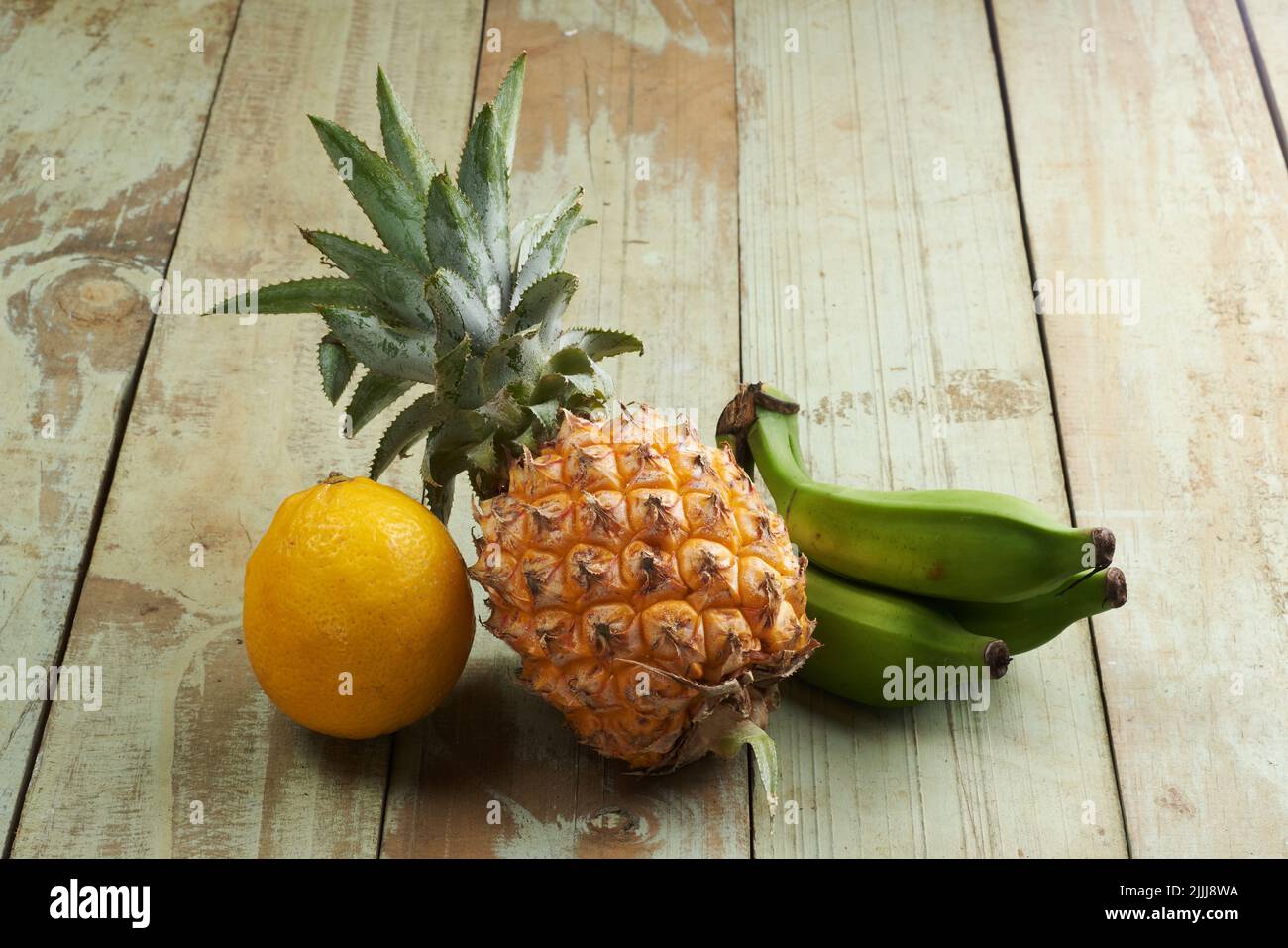 Lemons, pineapples and green bananas are tropical fruits that contain lots of vitamins Stock Photo