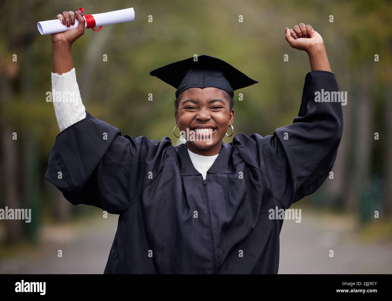 This is proudest moment of my life. Portrait of a young woman cheering on graduation day. Stock Photo