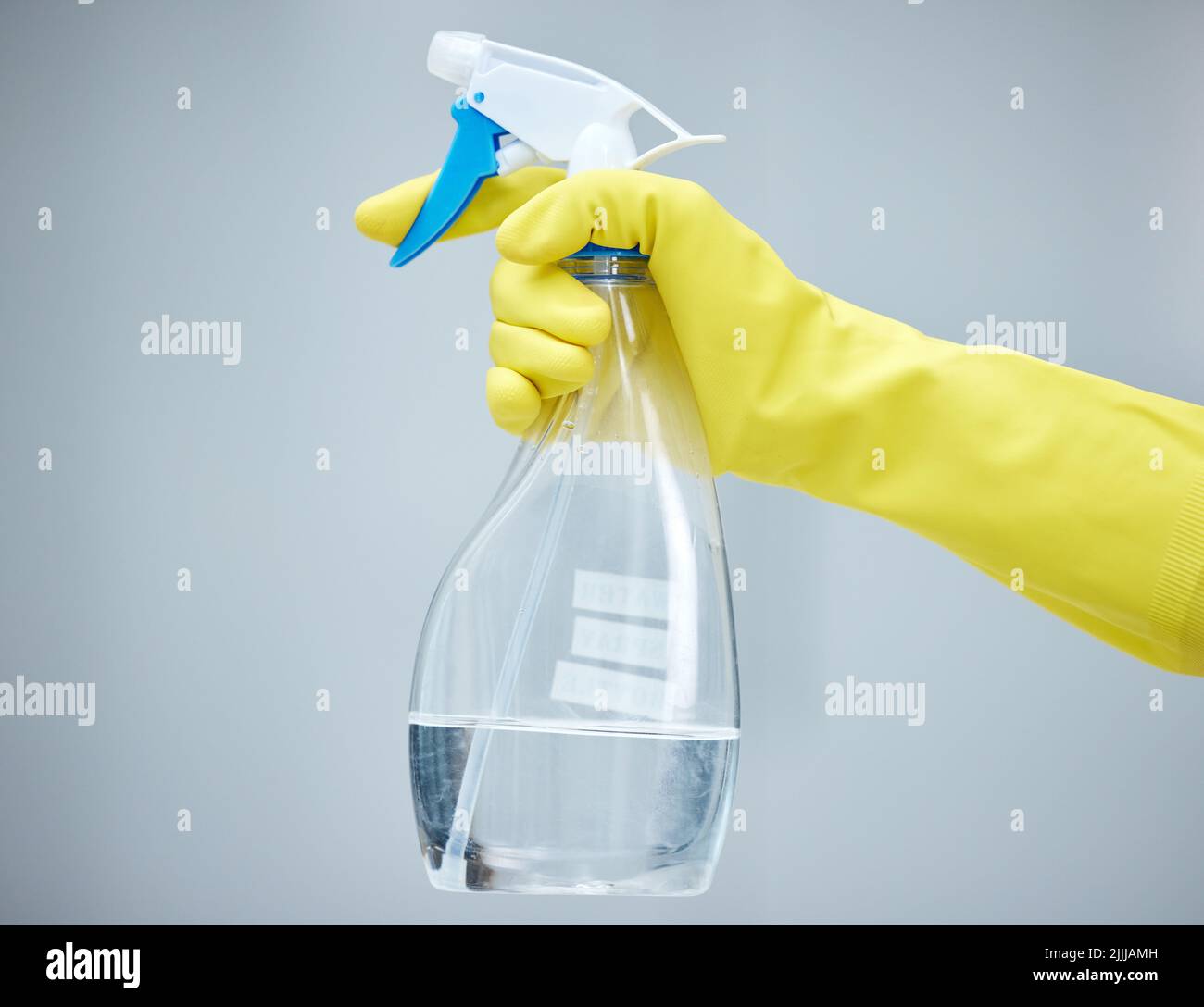 Keep your home safe and clean. a hand holding a spray bottle and