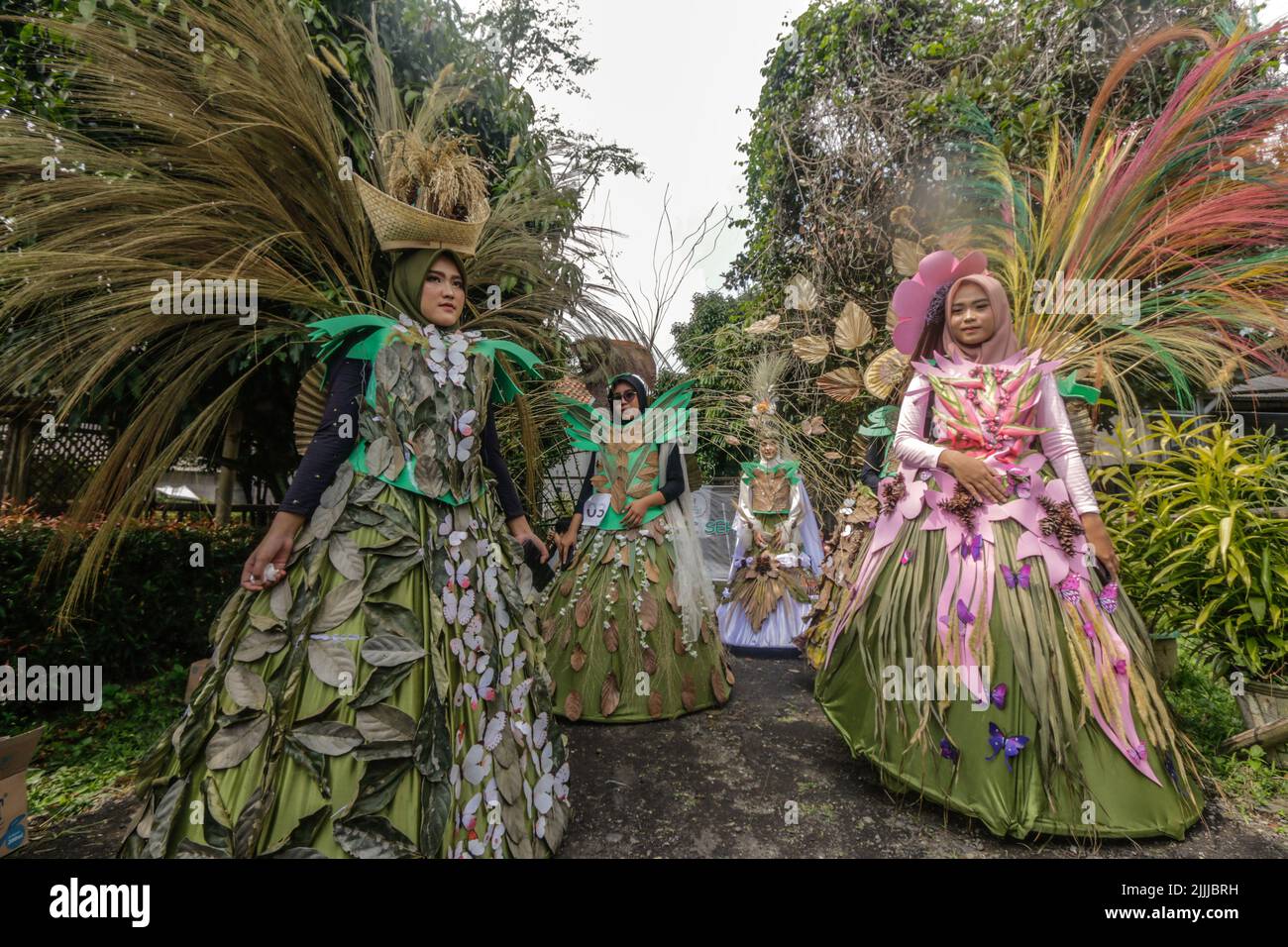 A woman in nature dress made from leaves, flowers, roots, participate in a nature fashion parade 'Back To Nature Cultural Preservation' Stock Photo