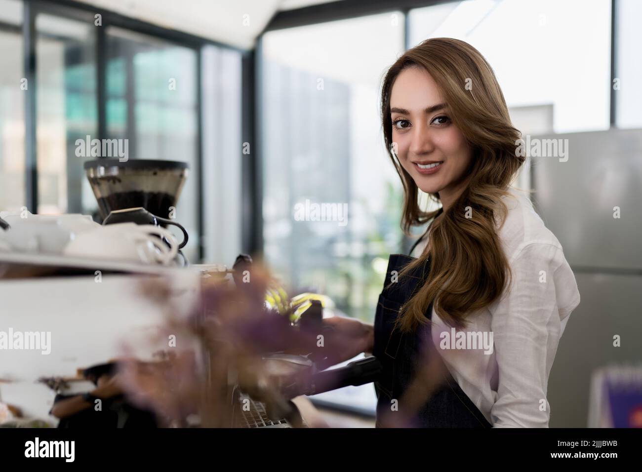 Portrait of asian barista cafe owner smiling and brew coffee. Stock Photo