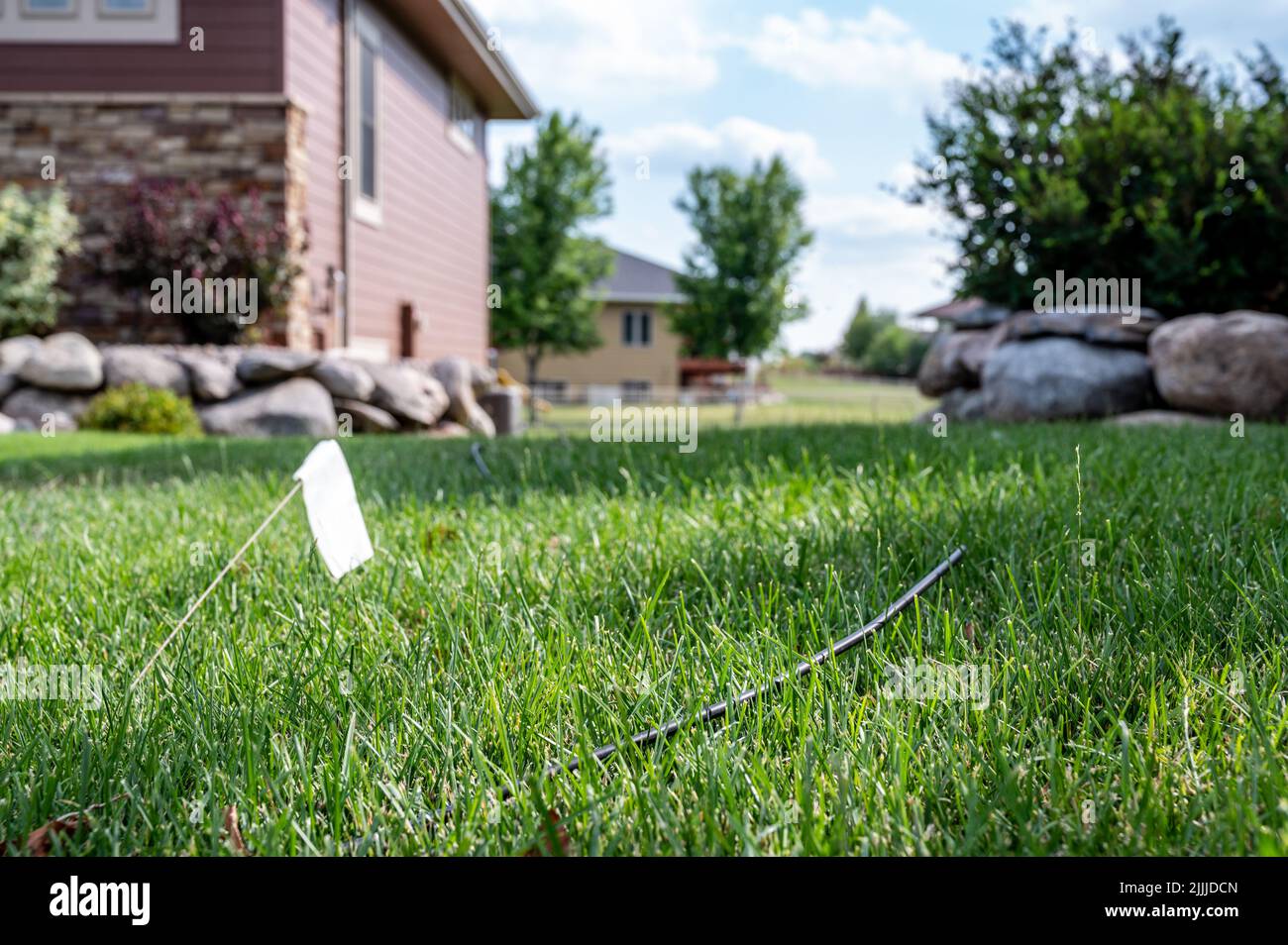Fiber optic cable laying in the grass ready to be installed at a