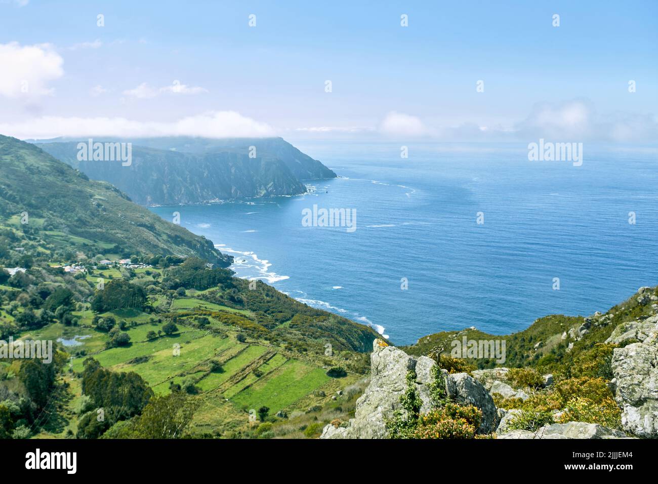 A mesmerizing scene of Vixia Herbeira green cliff by water in Santo Andre de Teixido in Galicia Stock Photo