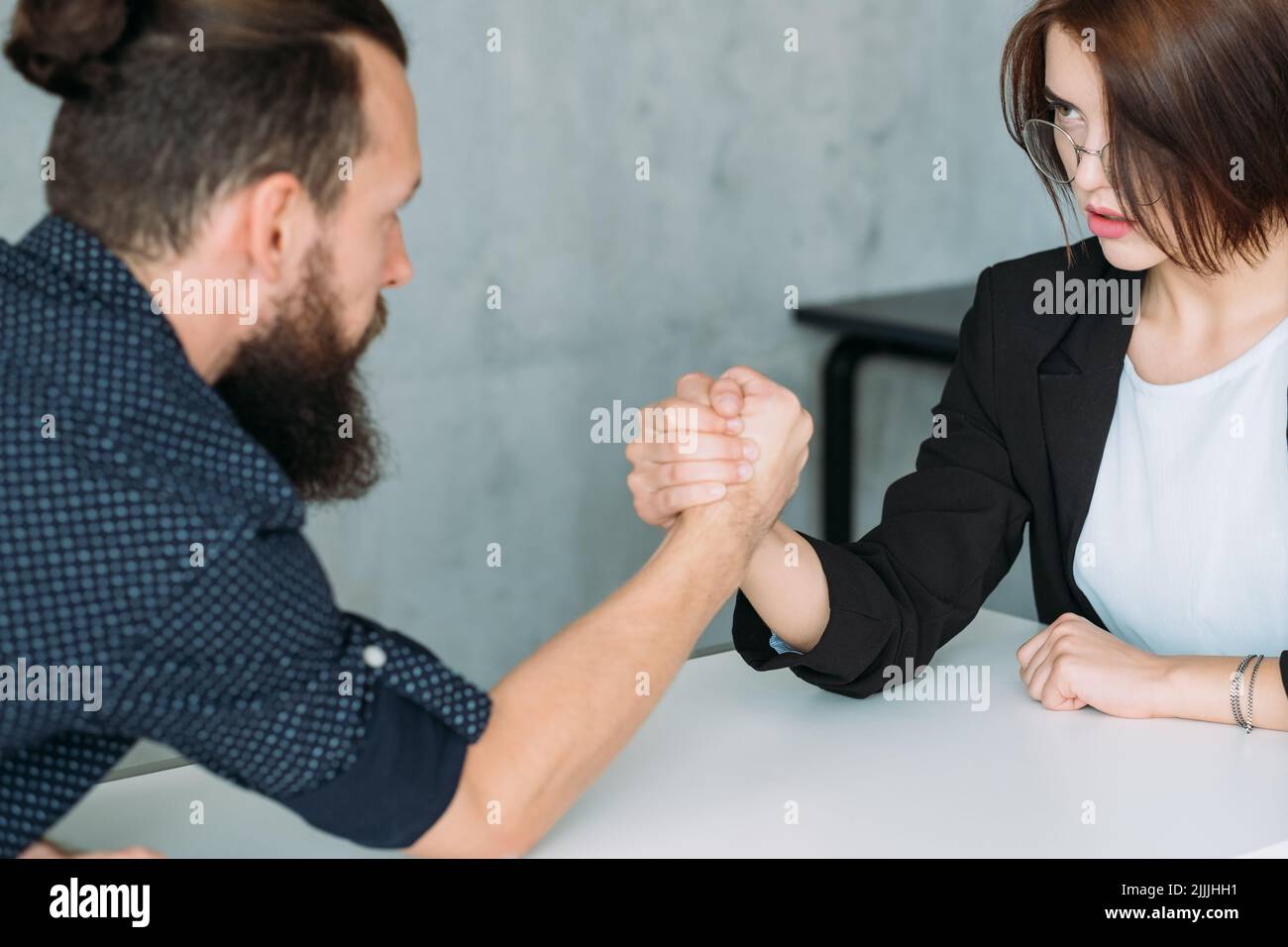 gender equality leadership man woman armwrestling Stock Photo