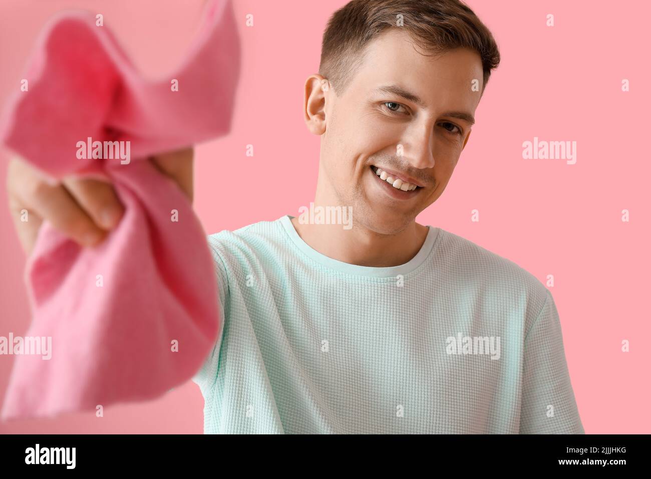 Young man with rag on pink background Stock Photo - Alamy