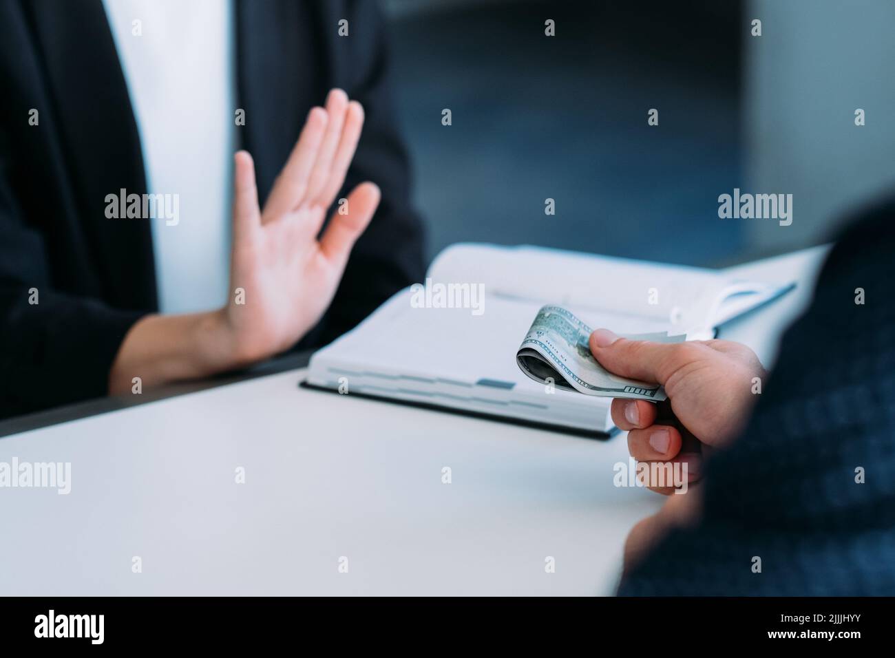 man offering money business woman refusal gesture Stock Photo