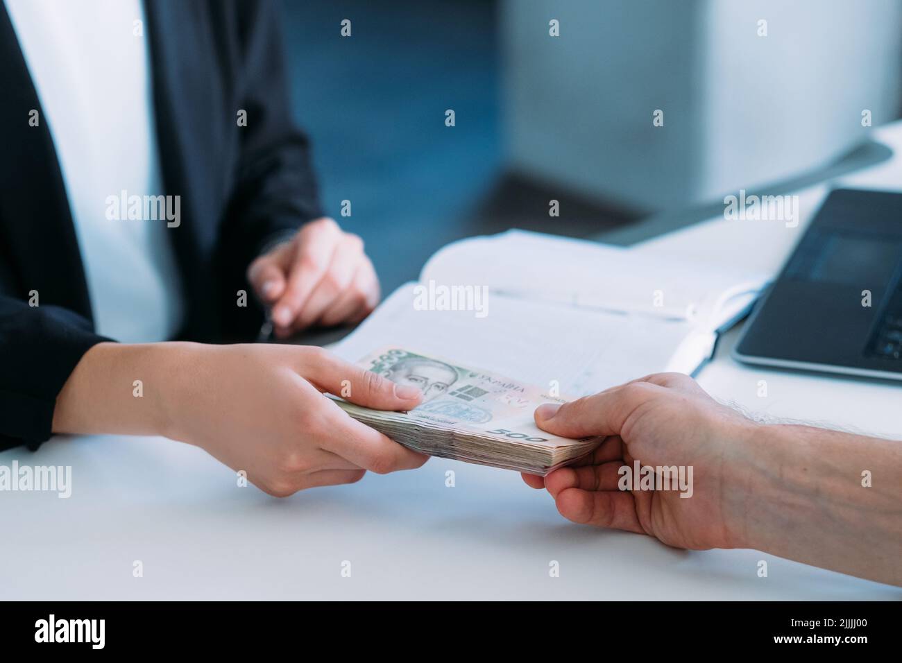 woman receiving money business bribery illegal Stock Photo