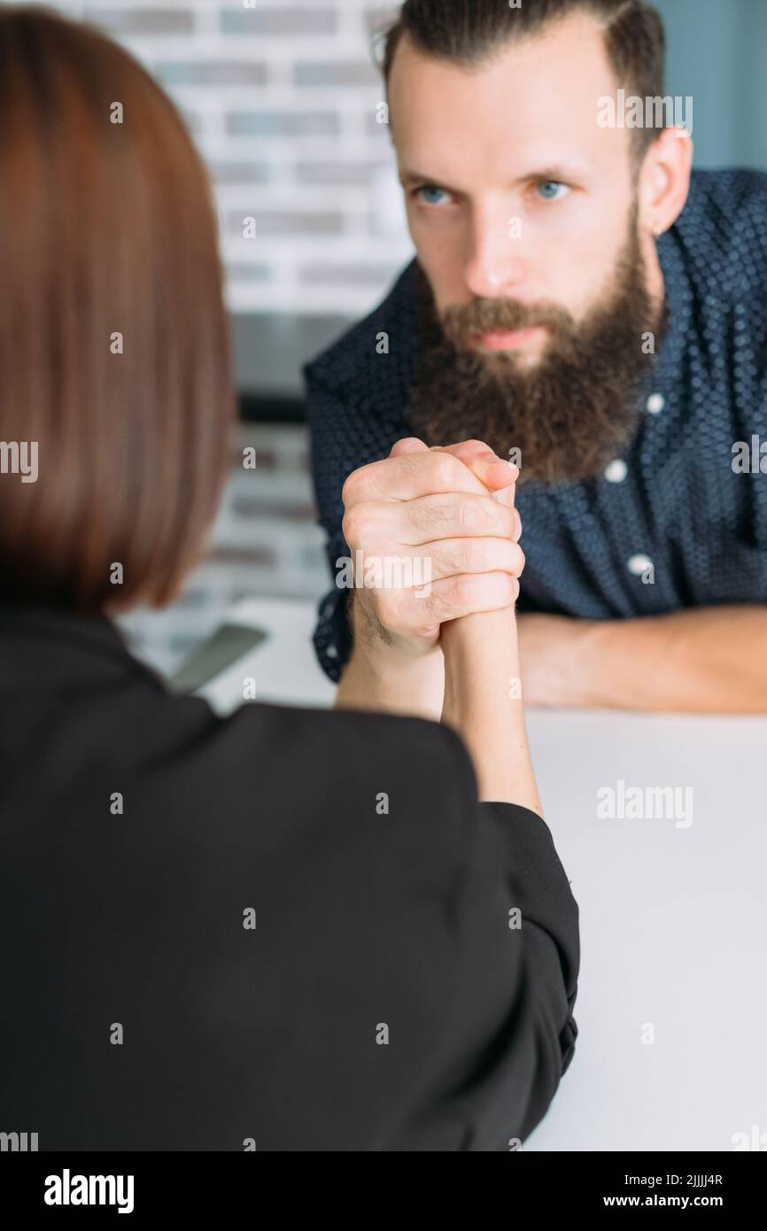 business man woman arm wrestling office conflict Stock Photo