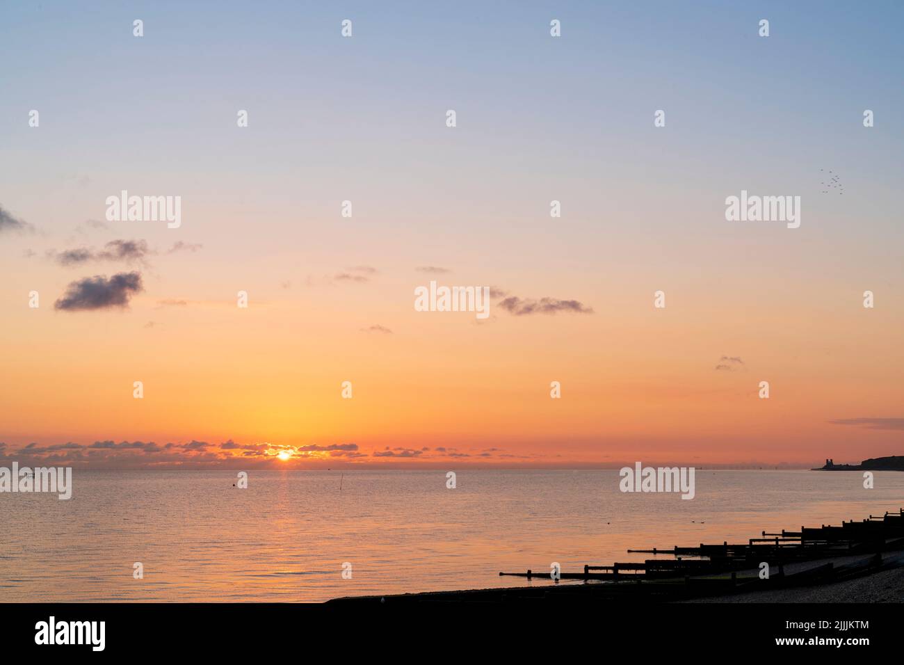 Herne Bay, Kent. 27/07/22. The sunrise over the North Sea seen from the seafront at the resort town of Herne Bay. A mostly clear sky promising sunshine and warm temperatures for the day. Credit-Malcolm Fairman, Alamy Live News. Stock Photo