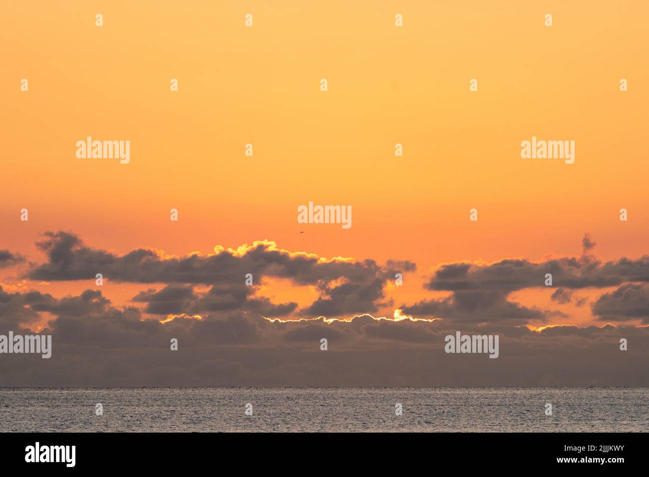 Herne Bay, Kent. 27/07/22. The dawn sky over the North Sea seen from the seafront at the resort town of Herne Bay. A mostly clear sky promising sunshine and warm temperatures for the day. Credit-Malcolm Fairman, Alamy Live News. Stock Photo
