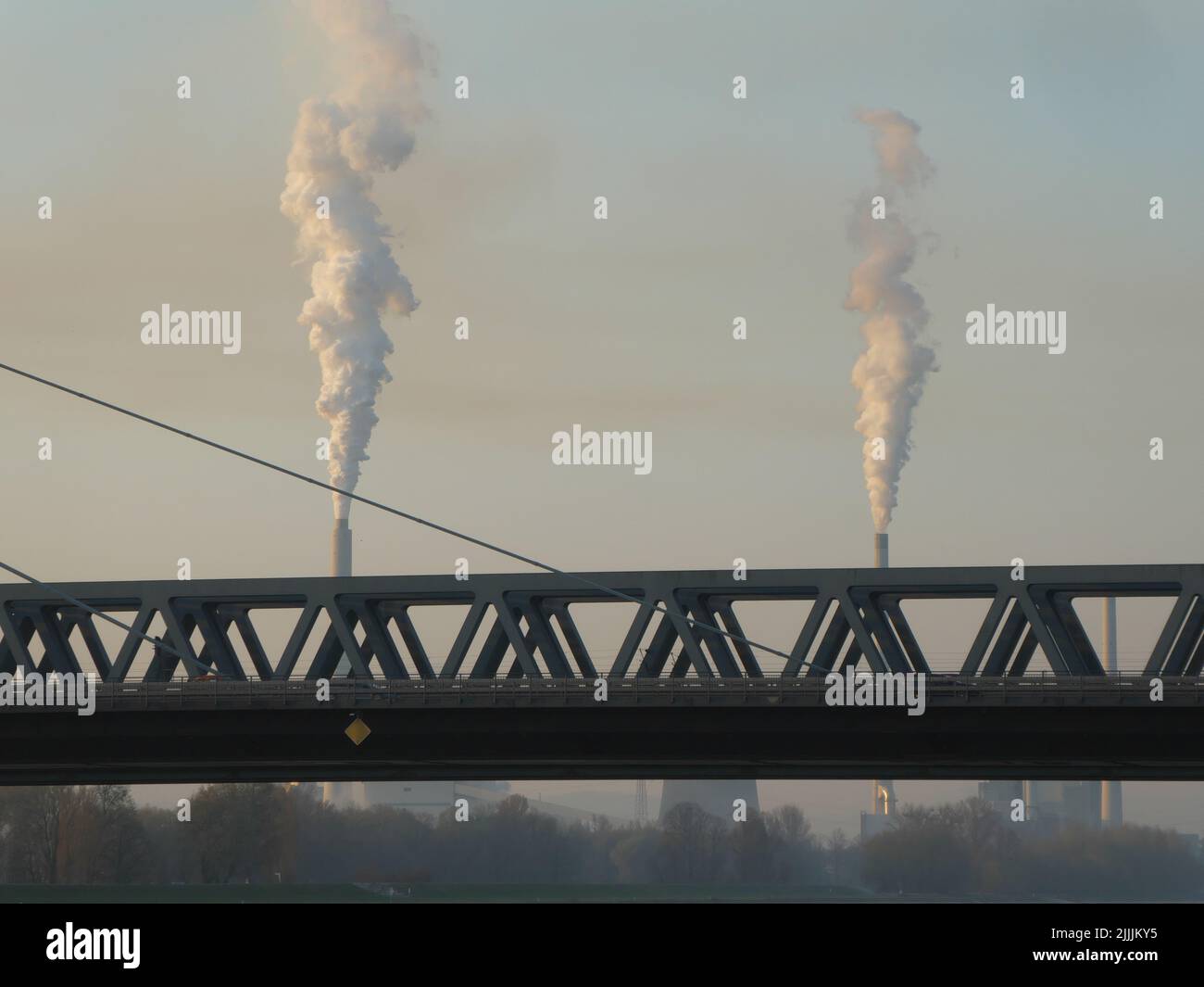 Part of the railway bridge Wörth with smoking chimneys of power station in background Stock Photo