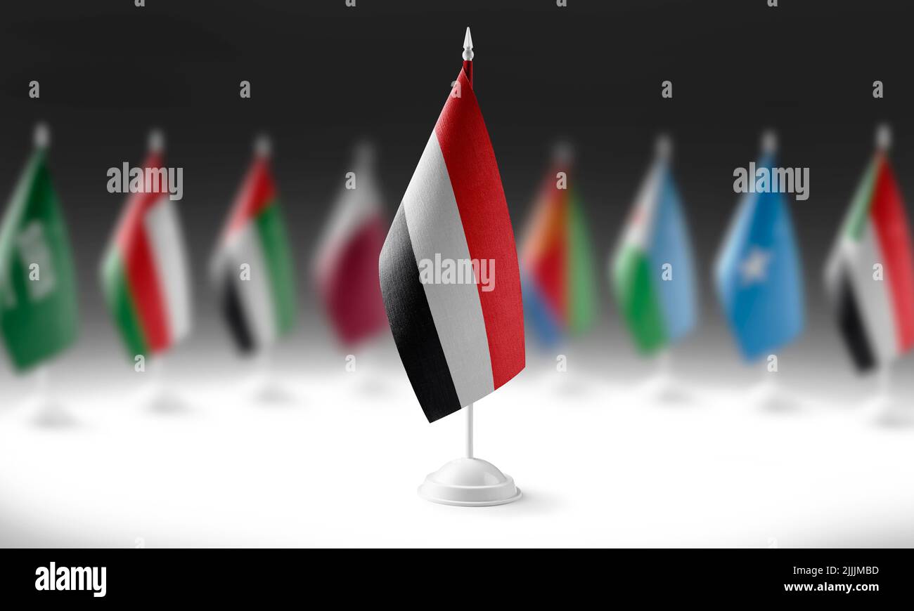 The national flag of the Yemen on the background of flags of other
