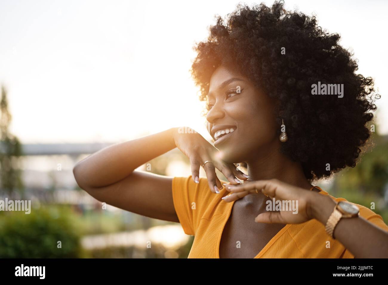 Portrait of a young african american woman smiling standing at the city ...