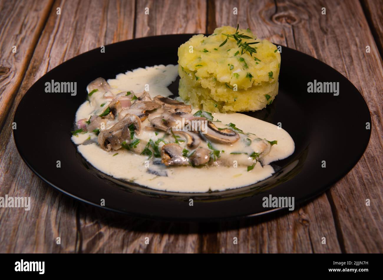Recipe for fillet of sea bream in white wine sauce with mashed potatoes and mushrooms Stock Photo