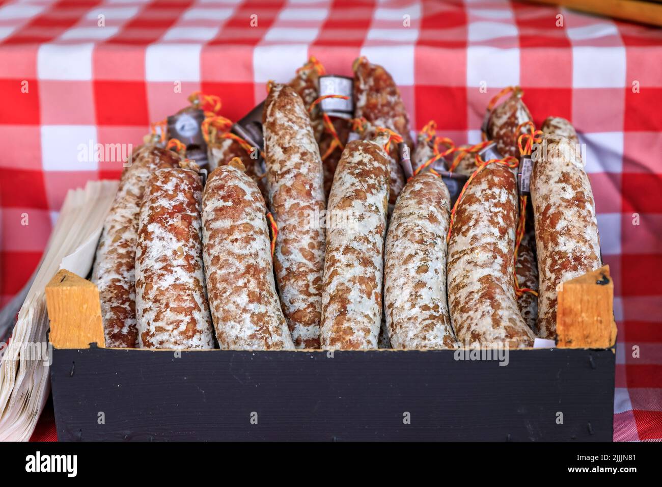Artisanal sausage in a box on a stand at a local farmers market Cours Saleya in Old Town, Vieille Ville in Nice, French Riviera, France Stock Photo