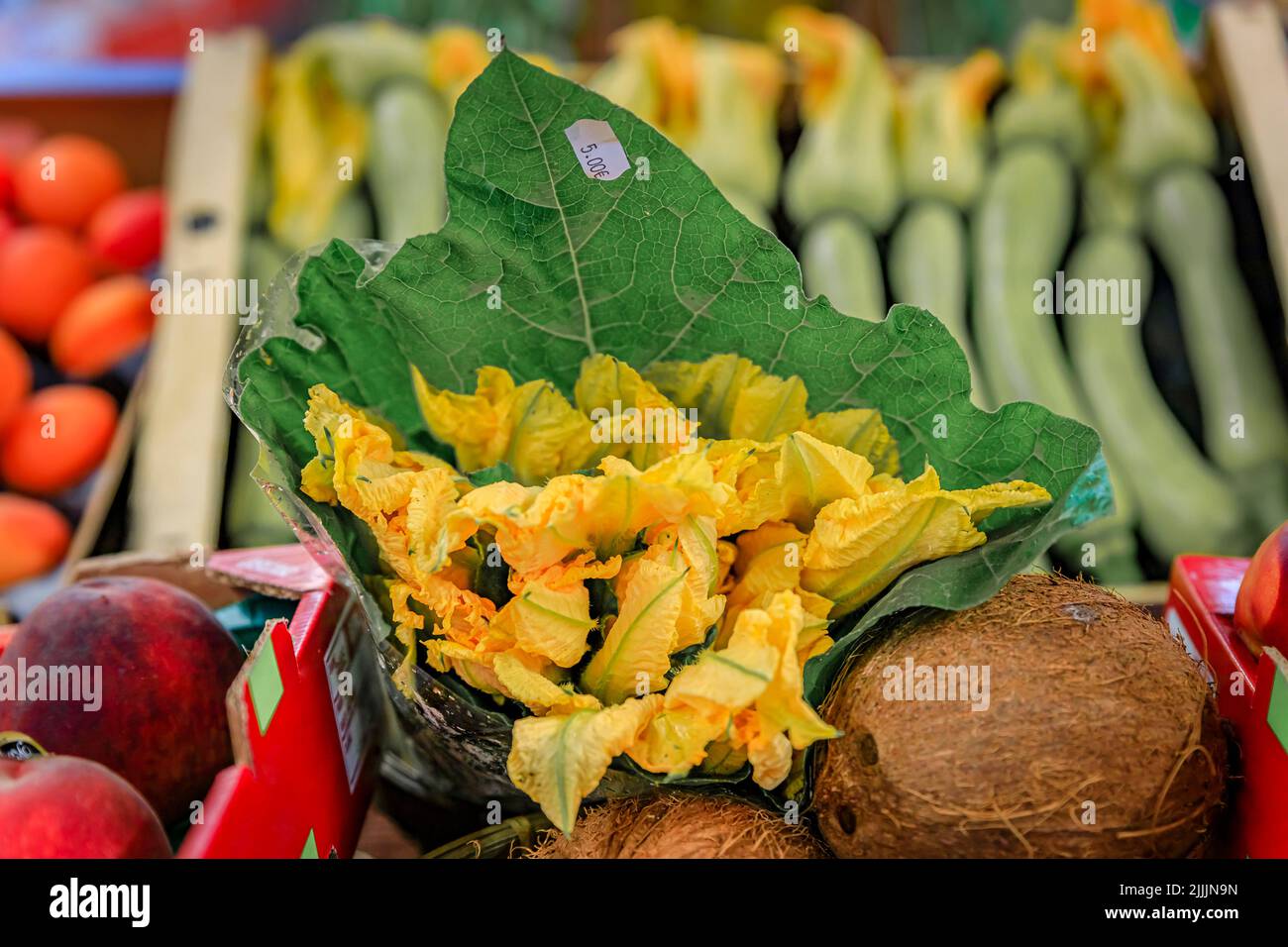 Traditional delicacy from South of France courgette or zucchini flowers at an outdoor farmers market Cours Saleya in the Old Town Nice, French Riviera Stock Photo