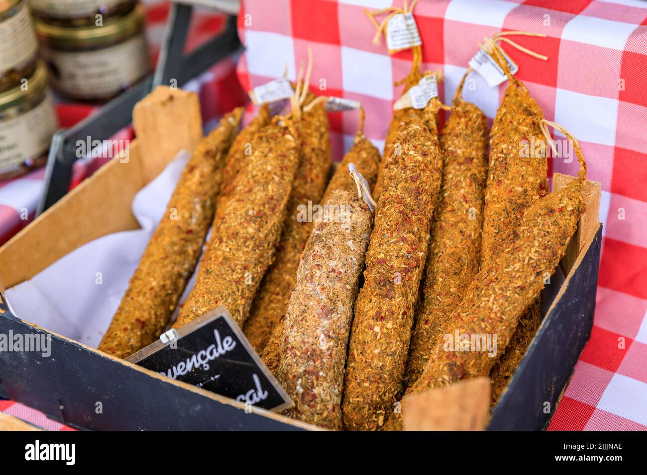 Artisanal sausage in a box on a stand at a local farmers market Cours Saleya in Old Town, Vieille Ville in Nice, French Riviera, France Stock Photo