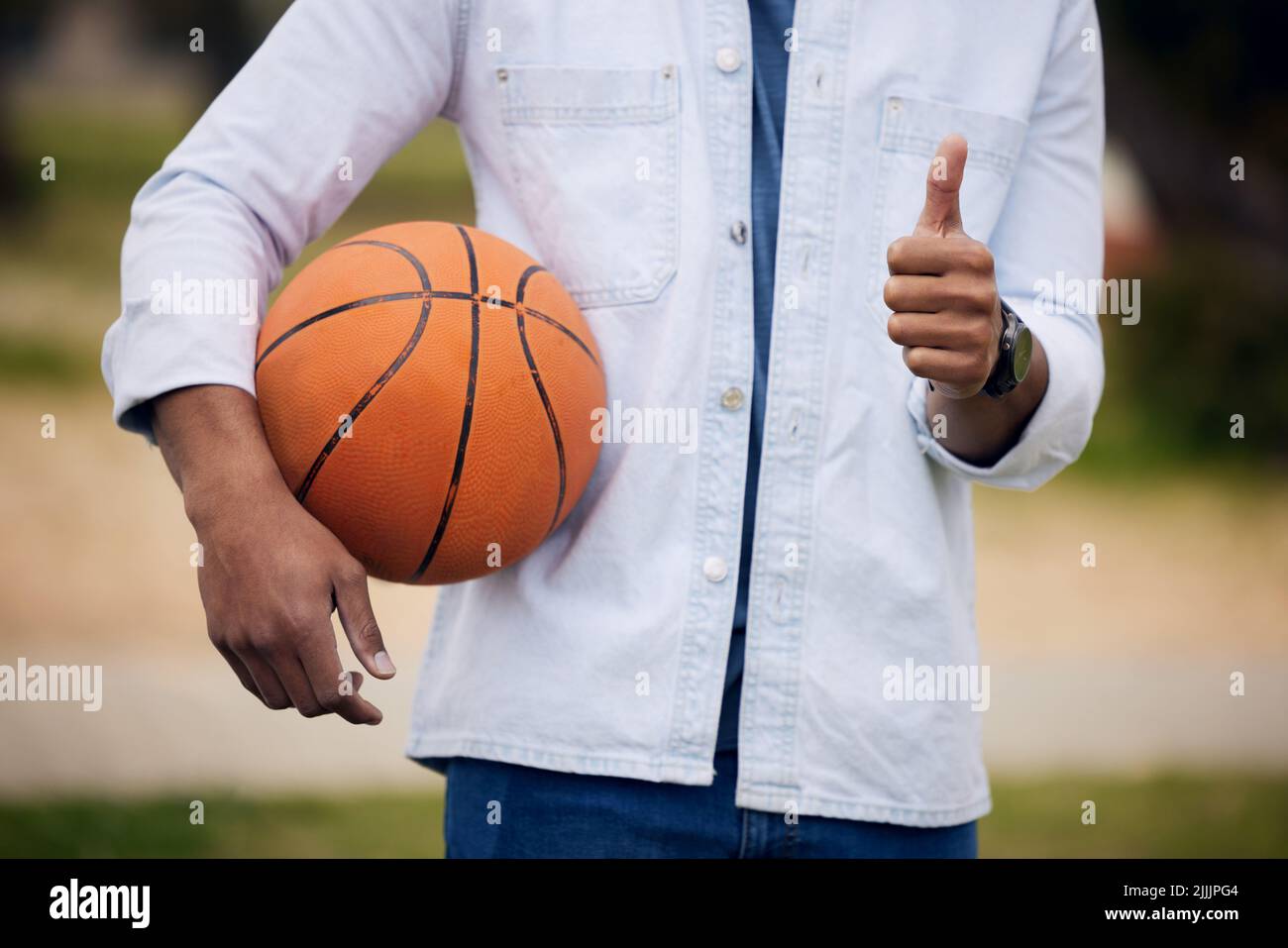 Score more with self belief. an unrecognisable man showing thumbs up