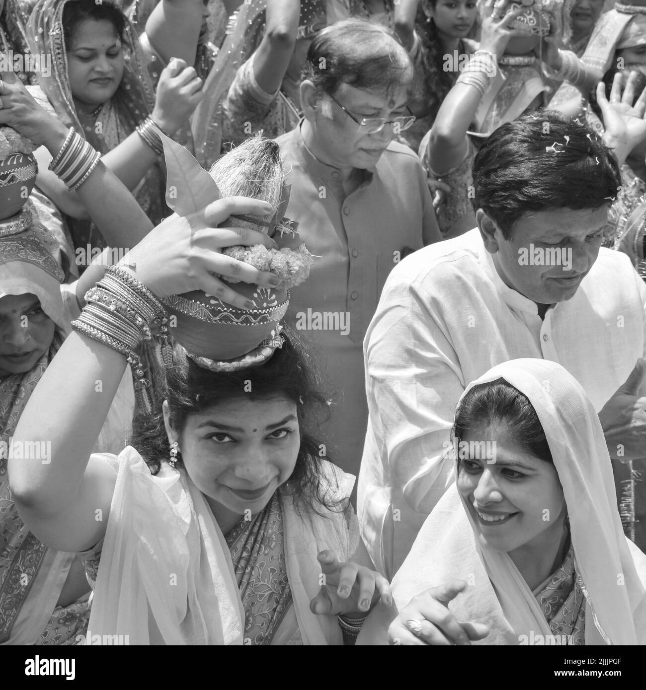 Delhi, India April 03 2022 - Women with Kalash on head during Jagannath Temple Mangal Kalash Yatra, Indian Hindu devotees carry earthen pots containin Stock Photo