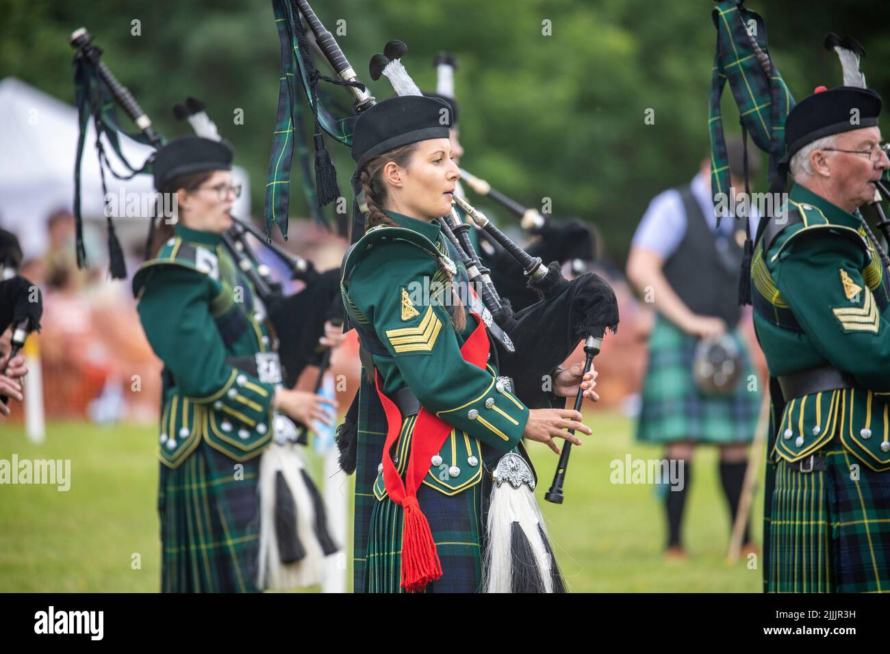 Young women female pipers at the Tomintoul 2022 Highland games, playing