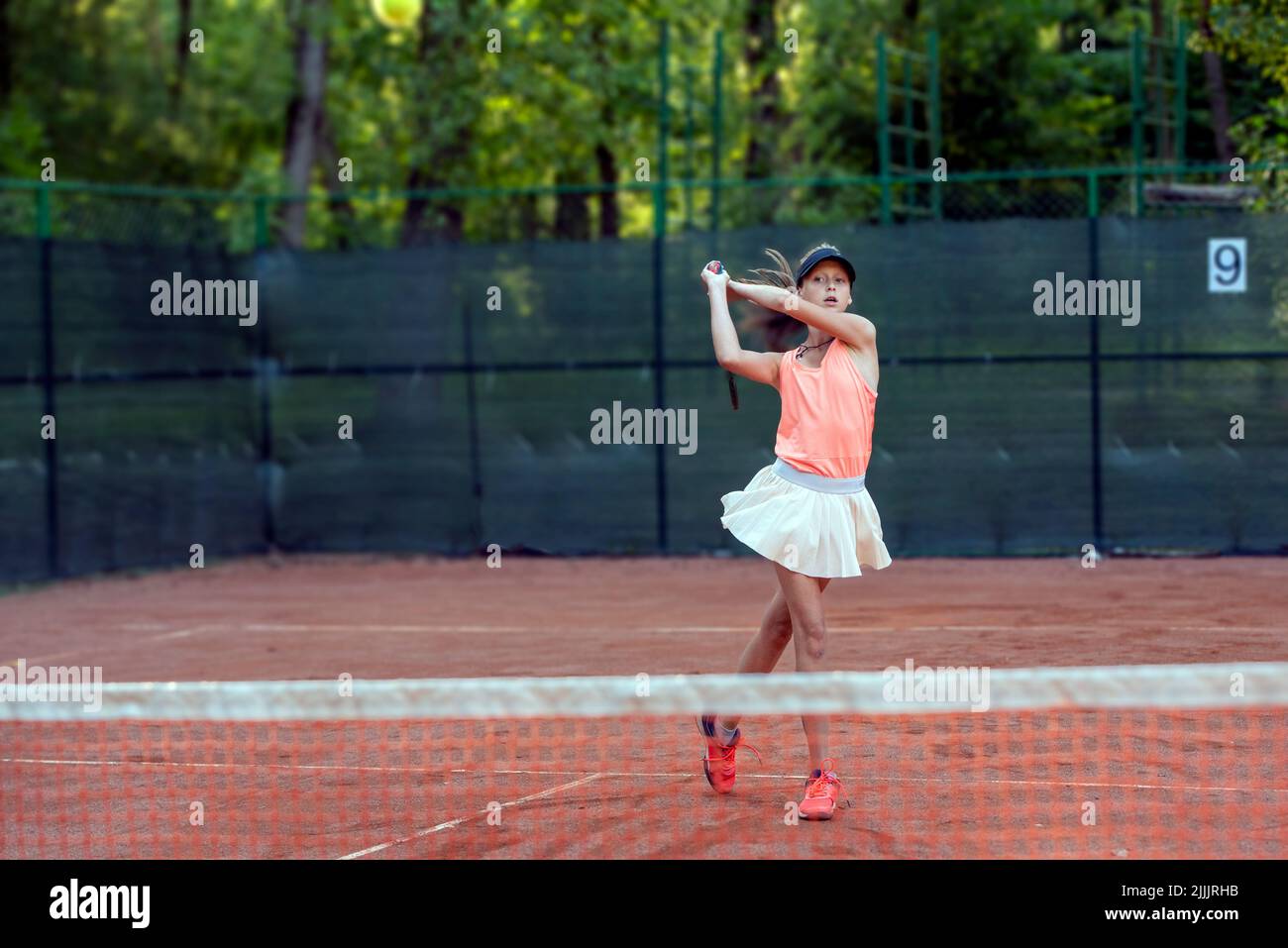 tennis girl player training in summer day in court Stock Photo