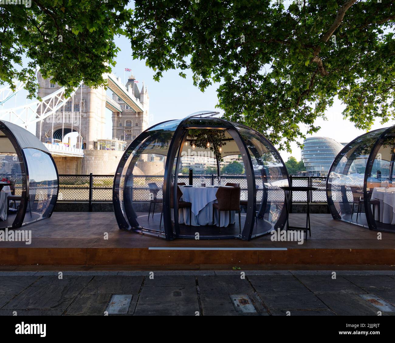 London, Greater London, England, June 22 2022: Glass Rooms restaurant beside the River Thames with Tower Bridge and City Hall in the background. Stock Photo