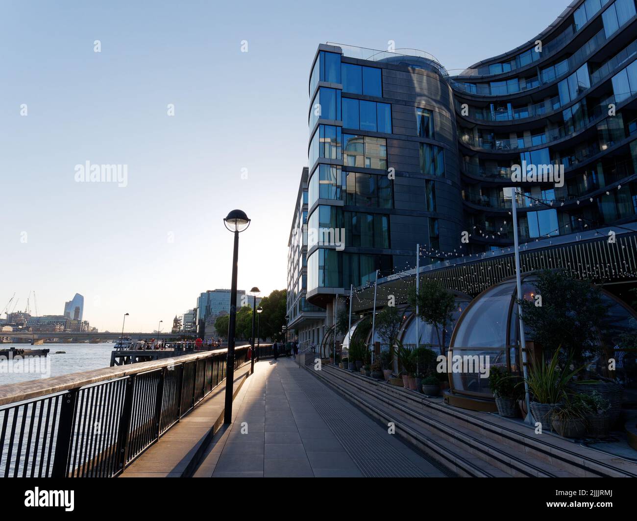 London, Greater London, England, June 22 2022: Apartments and Coppa Club restaurant Igloos on the north bank riverbank of the River Thames. Stock Photo
